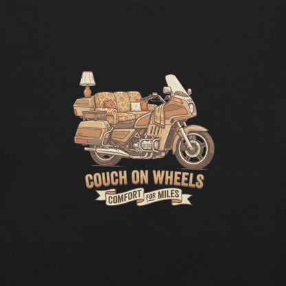 An illustrated 1980s Honda Goldwing featuring a floral couch as the seat, an end table, and a lamp mounted on the rear luggage, with the text Couch On Wheels, Comfort For Miles.